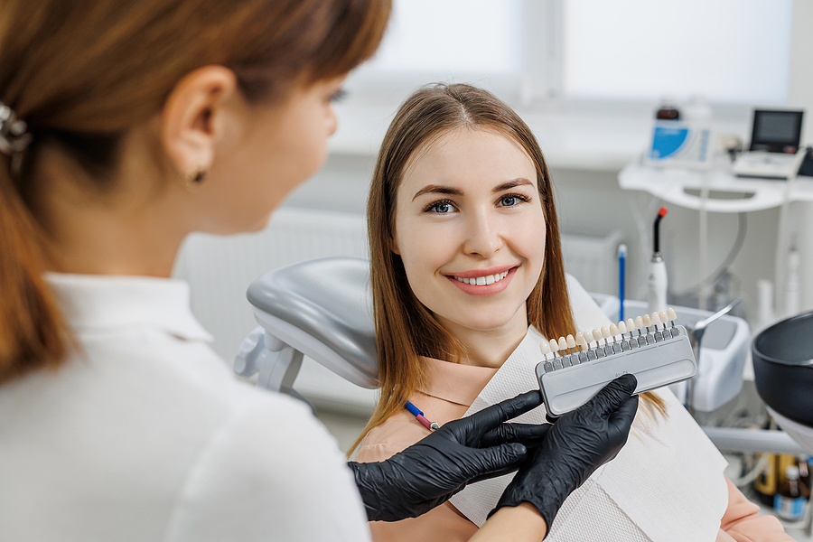Dentist Demonstrate For Patient Teeth Color Shades Guide For Too Porcelain Veneers